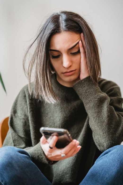 Person looking at an unknown number on their phone
